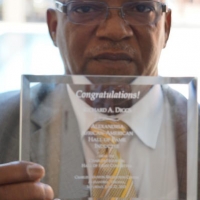 Inductee Diggs Poses with Award.jpg