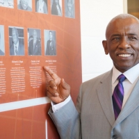 Inductee Pastor Hall Poses With Mural.jpg
